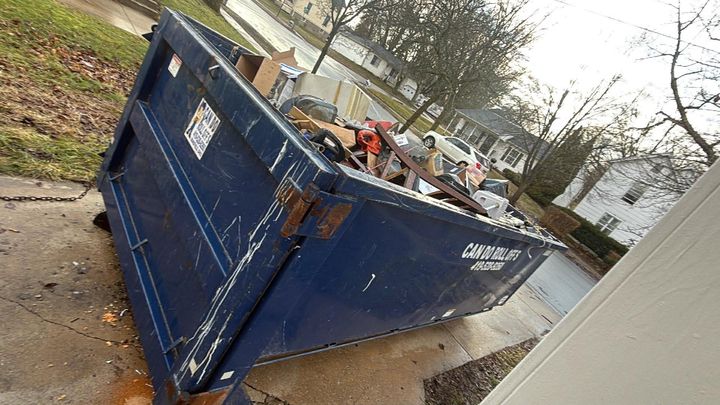 Roll-off dumpster loaded during an estate clean out (Estate Clean Out) by Moving Pros CLE
