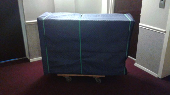 Furniture wrapped in moving blankets on a dolly (Full Service Moving) by Moving Pros CLE