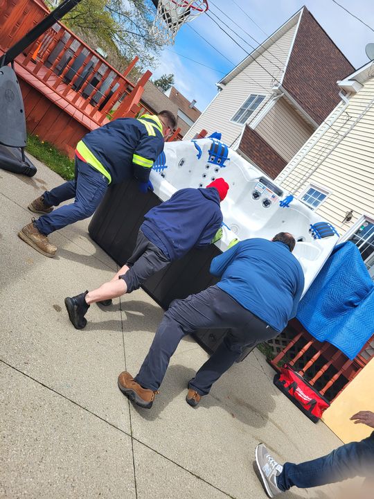 Crew moving a hot tub on a cart (Hot Tub Moving Services) by Moving Pros CLE
