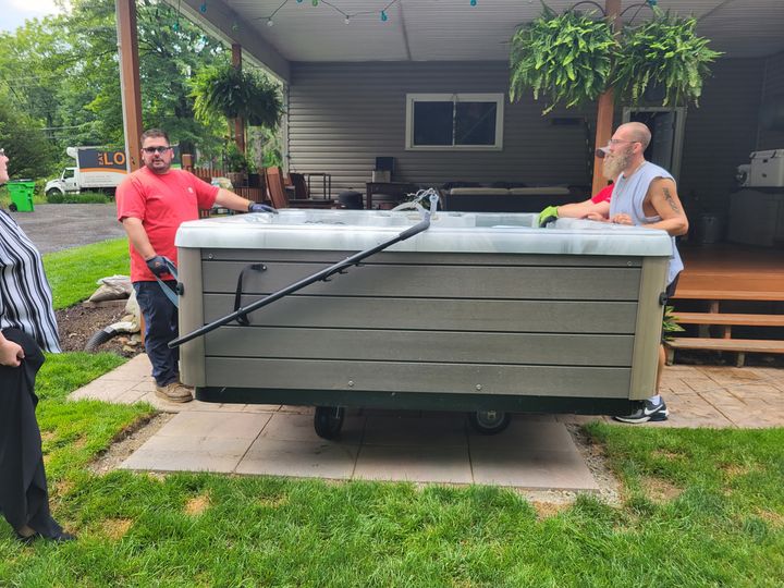 Crew positioning a hot tub on a patio (Hot Tub Moving) by Moving Pros CLE